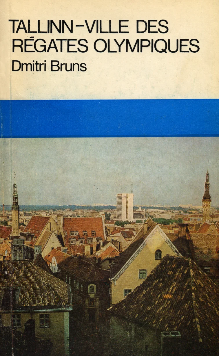 Tallinn - ville des régates olympiques - Dmitri Bruns (Perioodika, 1980). Fotorealistlik kaanepilt Tallinna vanalinna panoraamvaatega, kus on näha punakaspruunid katused, kirikutornid ja taustal kaasaegsem linnaosa. Foto on soojades pruunikates toonides ning raamitud sinise ribaga üla- ja alaosas.